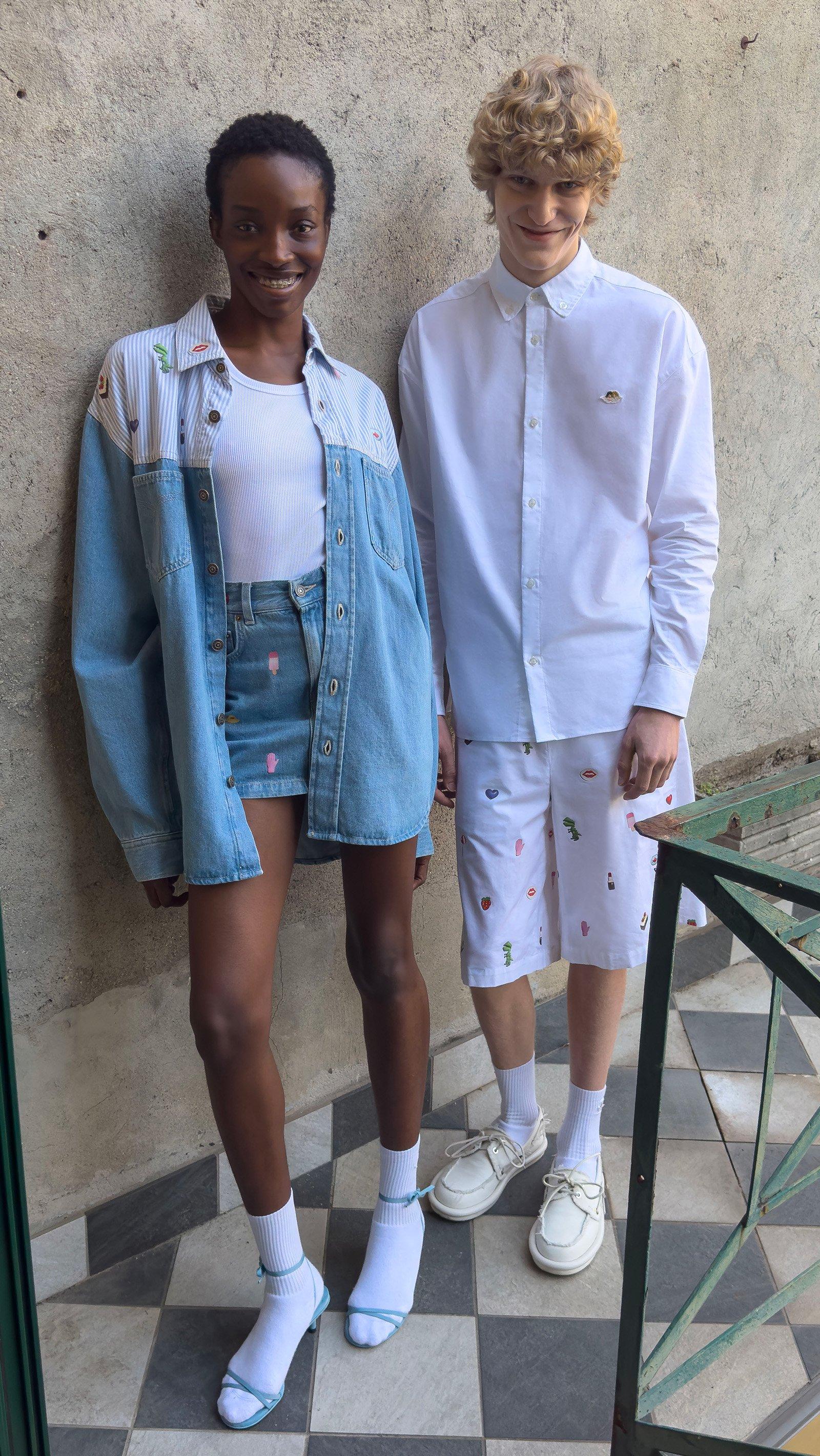 Models wear the Charm Print Denim Mini Skirt in Baby Blue, the Charm Print Denim Shirt in Baby Blue and the Charm Print Shorts in White.